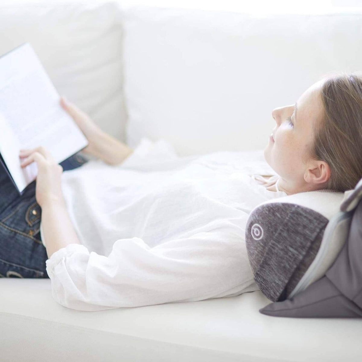Corron Roll-Up Massage Cushion in use on sofa