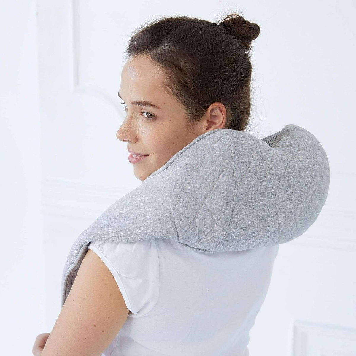 Quzy Cordless Heated Massager on woman's neck