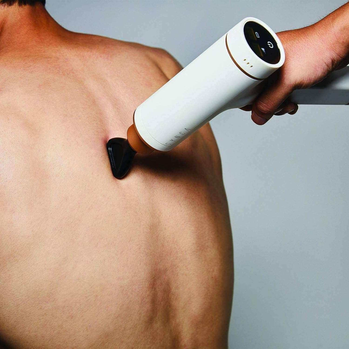 Kitta Massage Gun used on back muscle