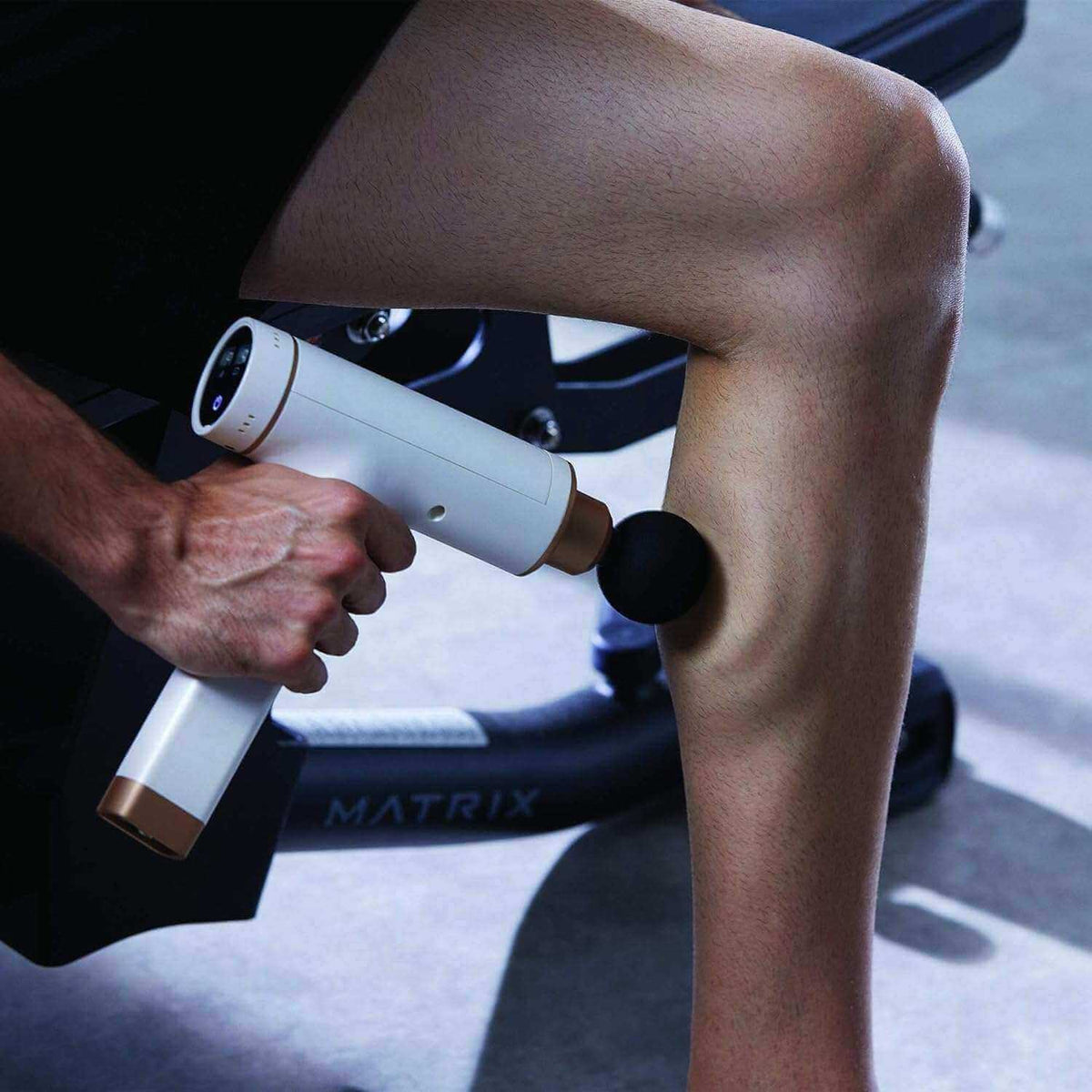 Kitta Massage Gun in use on calf muscle