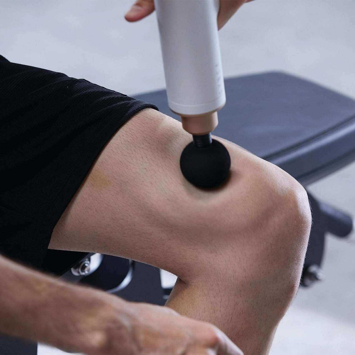 Kitta Massage Gun used on thigh muscle