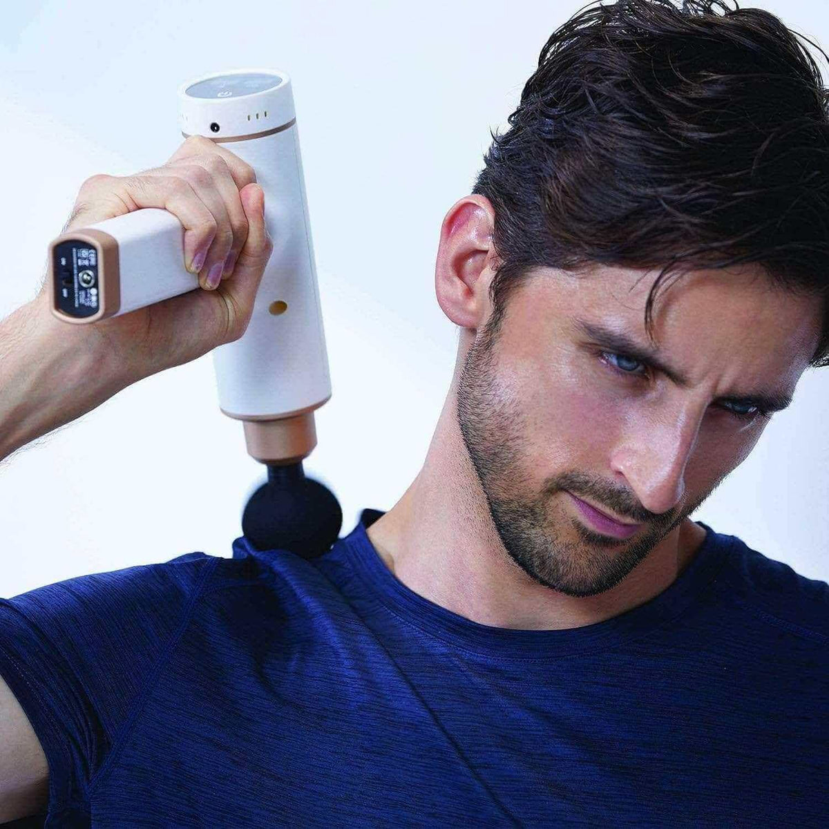 Kitta Massage Gun used on shoulder muscle