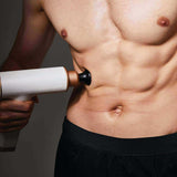 Kitta Massage Gun used on abdominal muscles