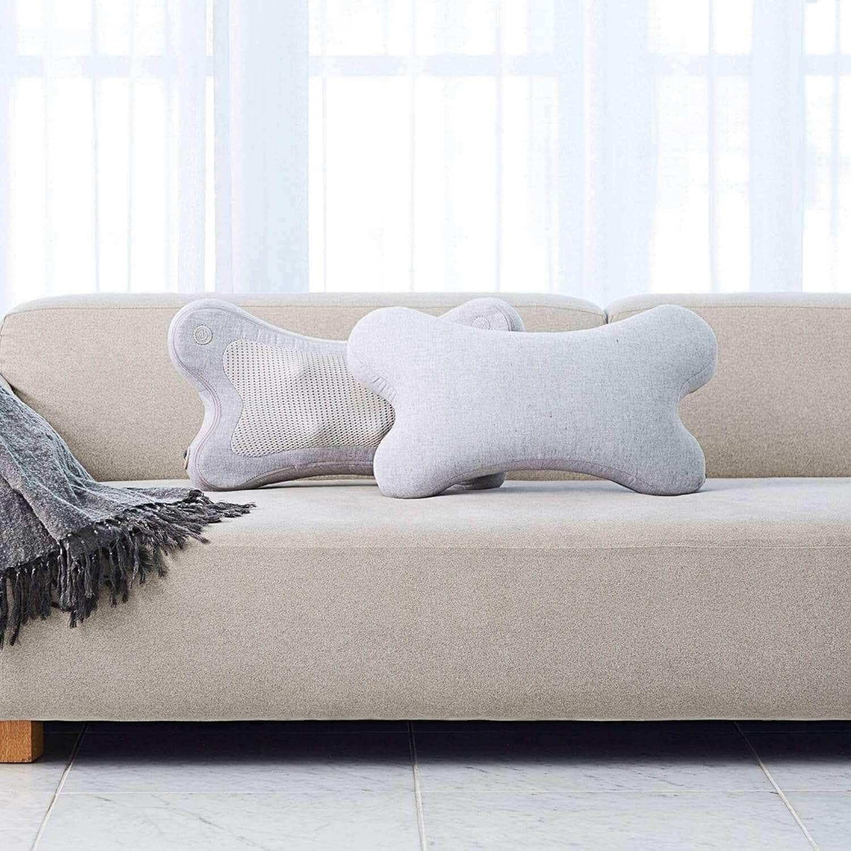 i-Puffy Massage Cushion on a beige sofa