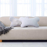 i-Puffy Massage Cushion on a beige sofa