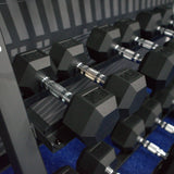 Gronk Fitness 3-tier dumbbell rack — close-up of 25 lb hex dumbbells on rails