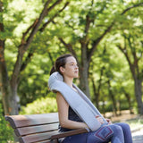 Quzy Cordless Heated Massager used outdoors on a park bench