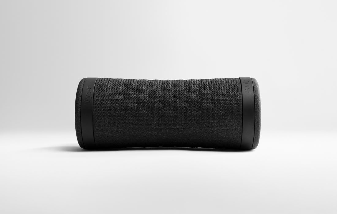 Side view of the textured black vibration roller lying on its side