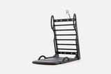 Open stretch station in black wood with horizontal rungs and a dark fold-out mat