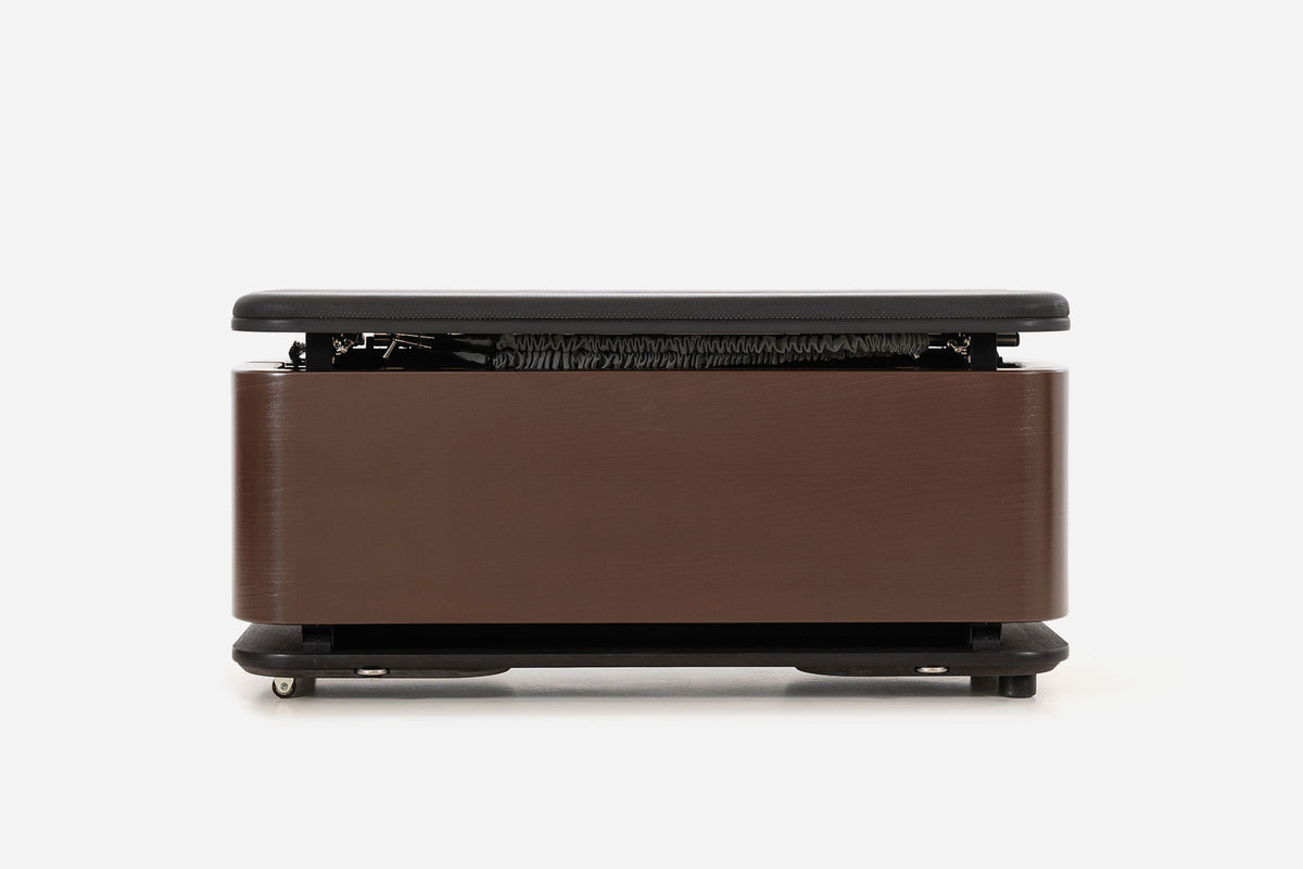 Front view of a dark reddish-brown storage bench with the padded lid raised and resistance bands visible inside