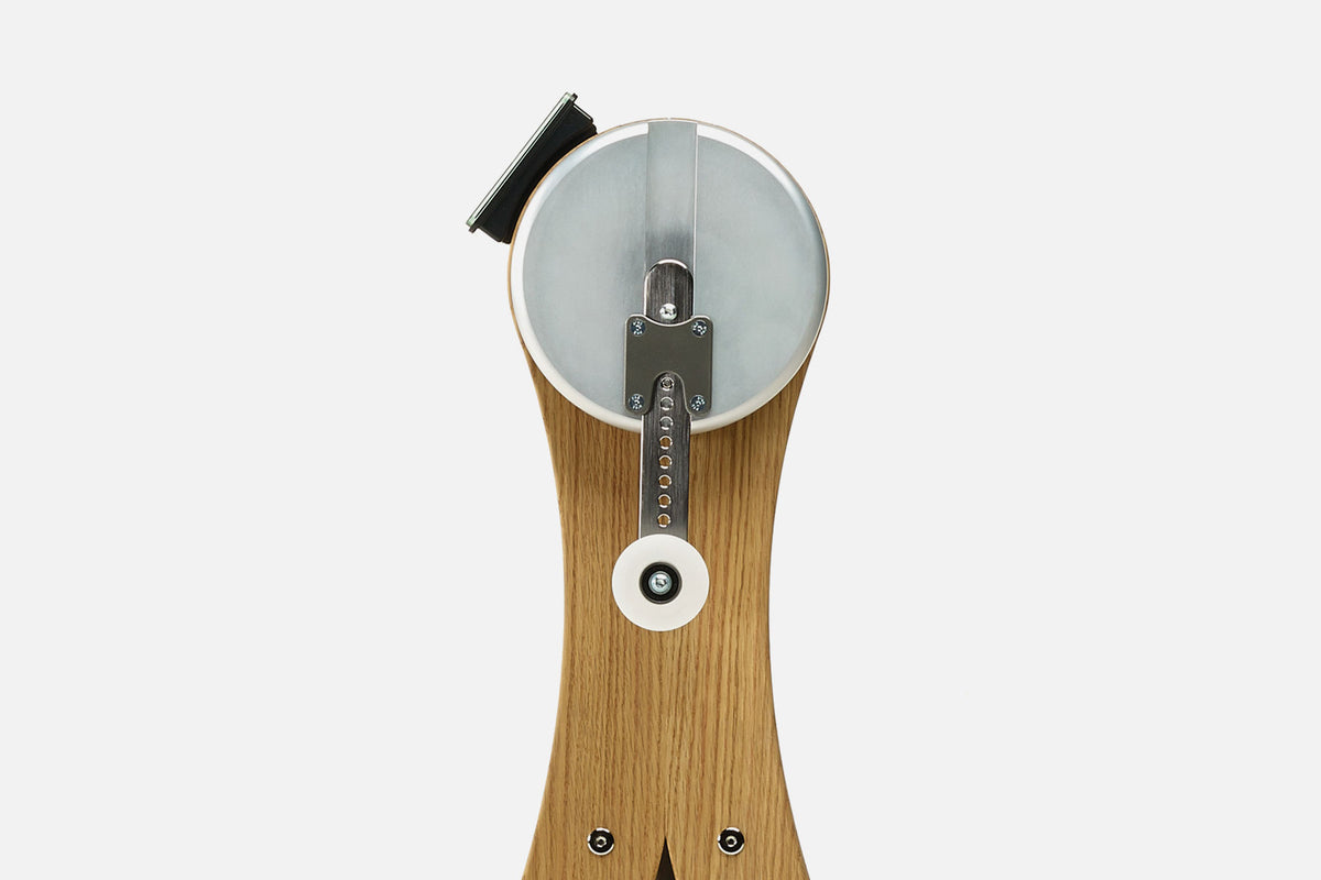 Close-up of the NOHRD WaterGrinder crank arm with handle positions on an oak wood frame